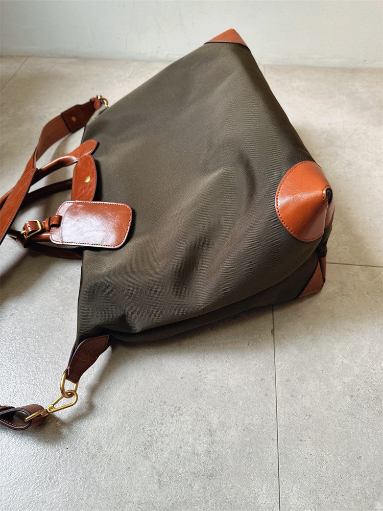 Close-up of cowhide leather handle on handmade recycled nylon commuter tote bag