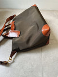 Close-up of cowhide leather handle on handmade recycled nylon commuter tote bag