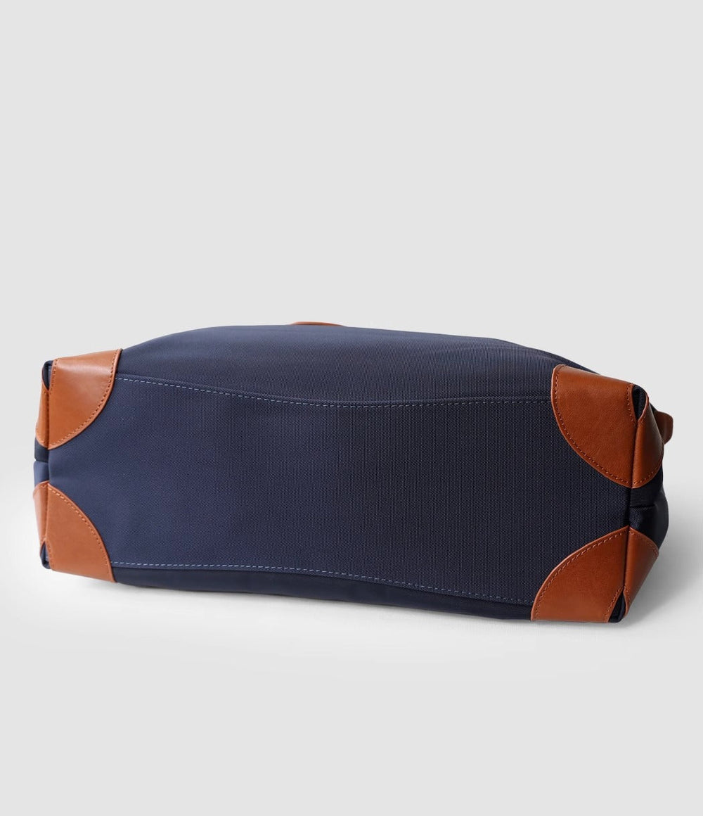 Recycled nylon cowhide work tote showing waterproof nylon body and leather trim