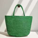 Handwoven raffia tote bag worn on shoulder – lightweight natural straw beach and market bag