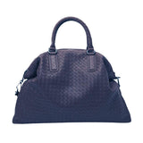 Large woven leather duffle bag with top handles, textured weave pattern, on white background