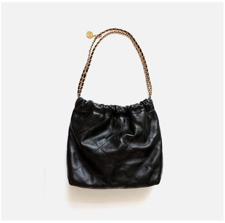 Black quilted leather shoulder bag with gold-tone chain handle on white background