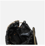 Interior of black calfskin leather shoulder bag with gold chain and zip pocket, minimalist tote