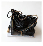 Black calfskin leather shoulder bag with gold-tone chain strap, elegant and minimalist style