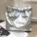 Silver quilted leather shoulder bag with gold-tone chain strap and minimalist design