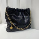 Black calfskin leather quilted shoulder bag with gold chain strap and flower charm on white background