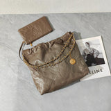 Taupe quilted leather shoulder bag with gold chain strap and matching leather pouch on marble surface