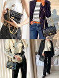 Woman in white shirt carrying black quilted leather shoulder bag with gold chain strap