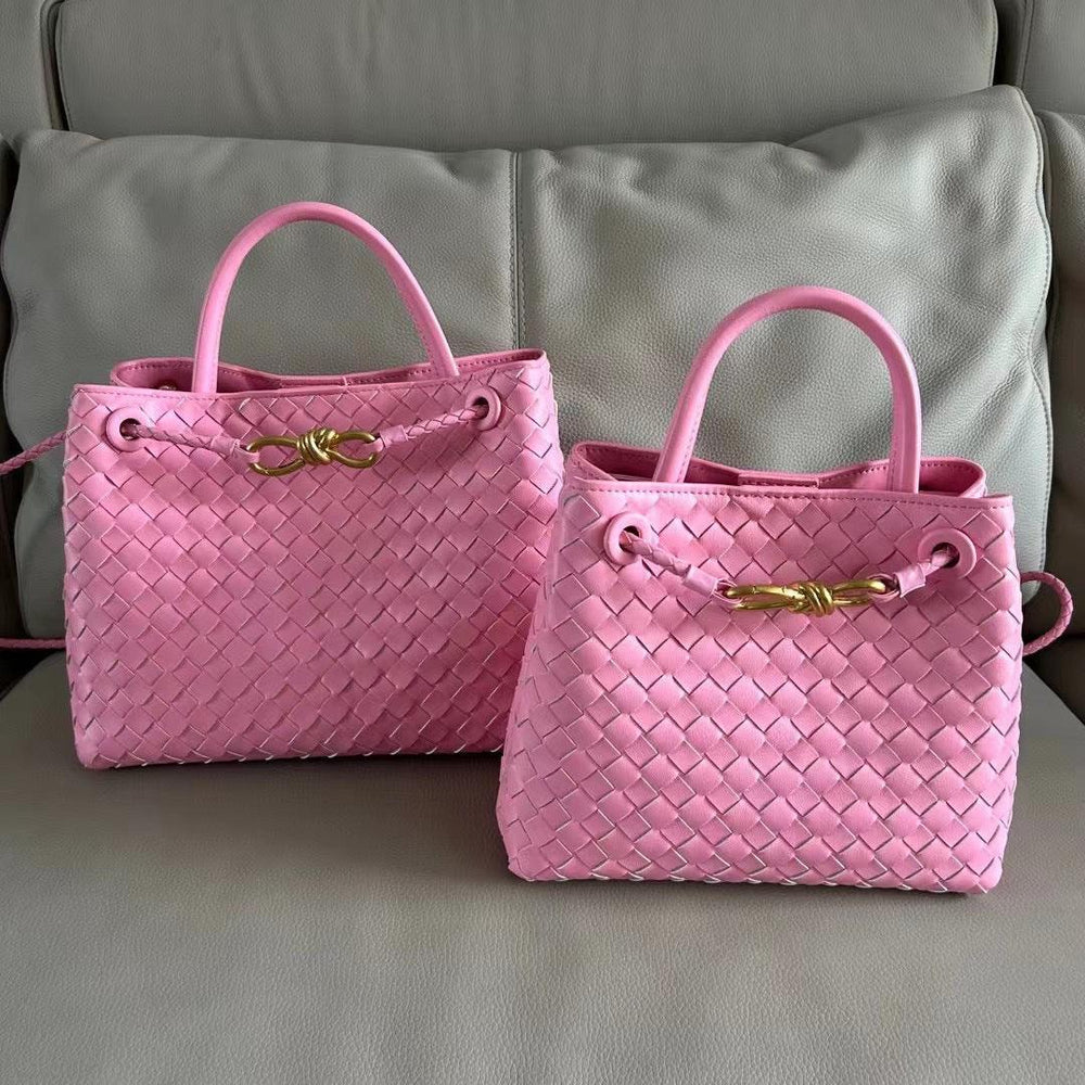 Pink woven leather shoulder bags with gold metal buckles on a beige sofa