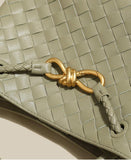 Woven cowhide leather shoulder bag in sage green with gold knotted metal buckle detail