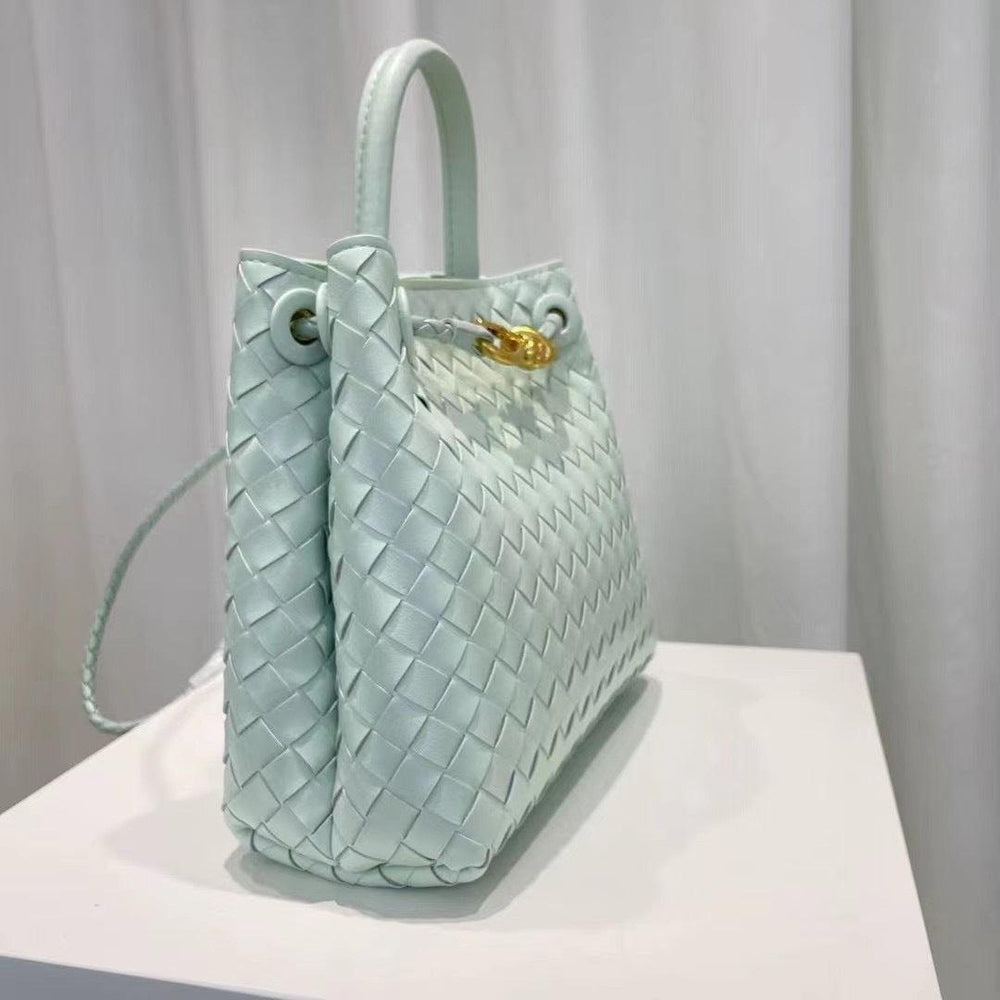 Light blue woven leather shoulder bag with top handle and gold metal buckle detail