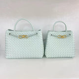Light blue woven leather shoulder bags with gold metal buckle on white background