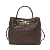 Brown woven cowhide leather shoulder bag with gold metal buckle and braided handles