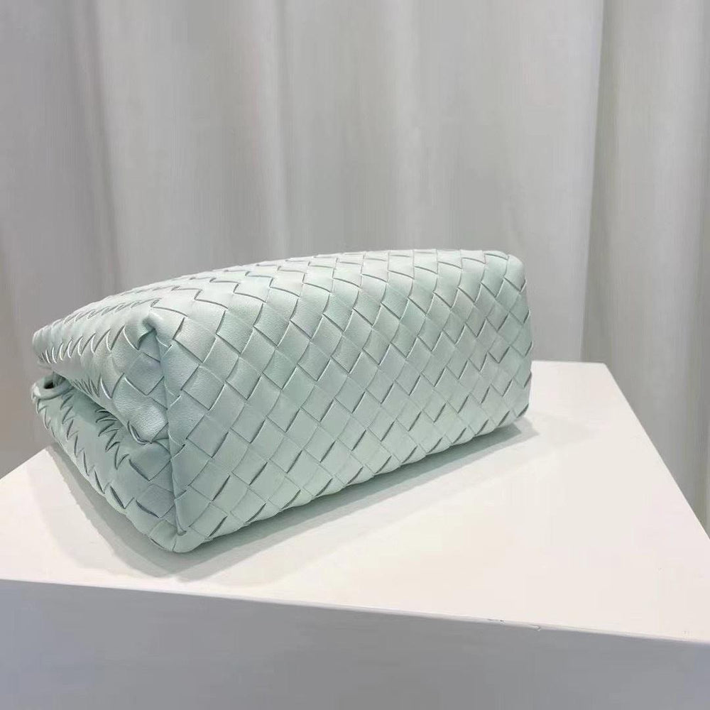 Light blue woven leather shoulder bag with knotted intrecciato design on display
