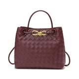Burgundy woven cowhide leather shoulder bag with gold metal buckle and top handle
