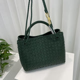 Dark green woven leather shoulder bag with braided straps and gold-tone metal buckle