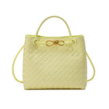Yellow woven leather shoulder bag with top handle, braided strap, and gold metal buckle