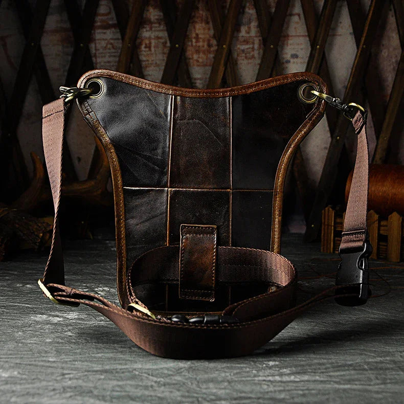 Full grain dark brown leather leg bag with zipper pockets and metal rivet details
