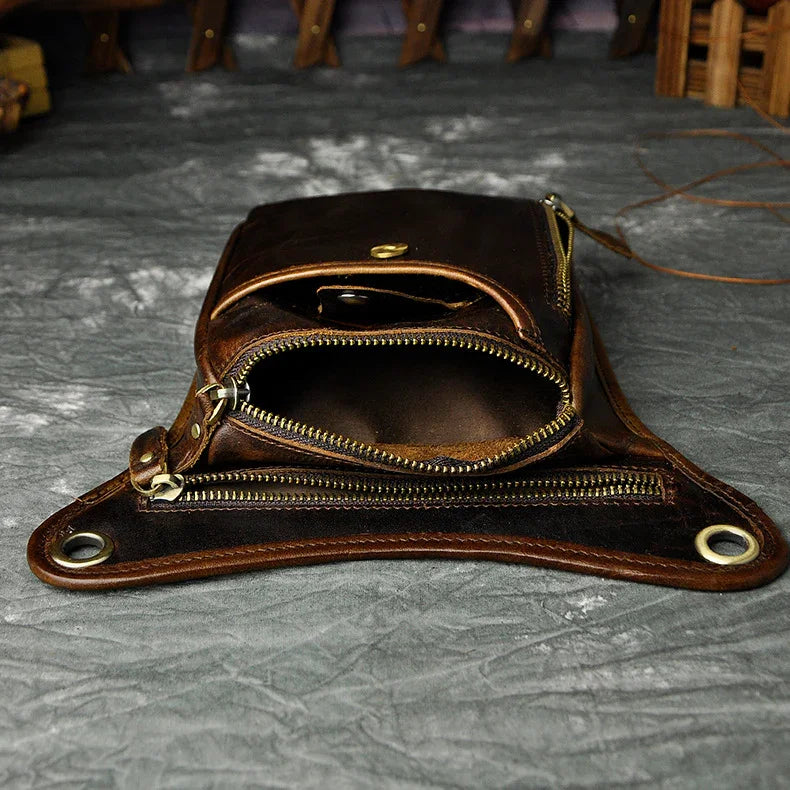 Full grain dark brown leather leg bag with zipper pockets and metal rivet details