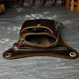 Full grain dark brown leather leg bag with zipper pockets and metal rivet details