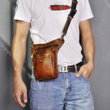 Brown full-grain leather waist bag with zipper and front pocket worn crossbody by a man