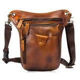 Brown full grain leather leg bag with multiple zippered pockets and adjustable strap