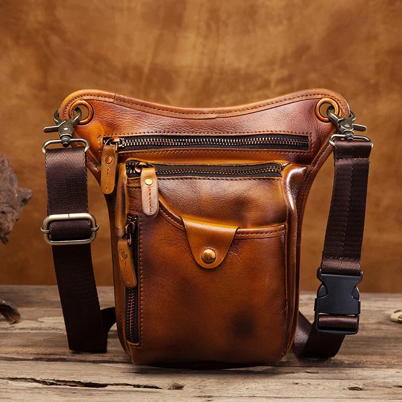 Full grain leather motorcycle leg bag with multiple zippered pockets and adjustable straps, brown finish