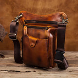 Full grain brown leather leg bag with adjustable strap, zip pockets, rustic wood background