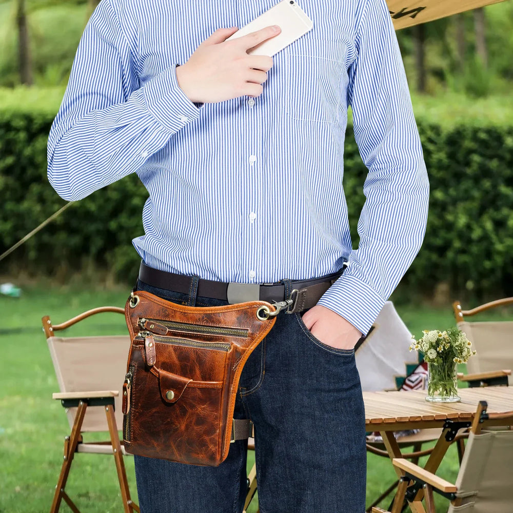 Full grain leather leg bag for men, worn at the waist, with zipper pockets, outdoor setting Red Brown