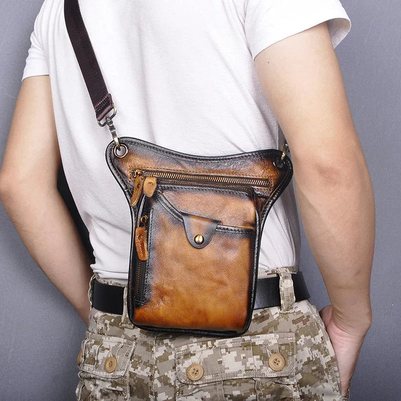 Full grain leather leg bag with zip pocket and flap, worn by person in camouflage pants.