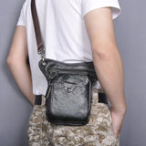Full grain leather leg bag for men, black, with zip and snap pockets, worn crossbody