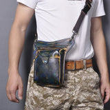 Full grain leather leg bag with multi-zip pockets worn on waist, camouflage pants visible