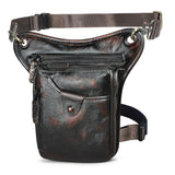 Full grain leather leg bag with front zipper and snap pocket, adjustable straps, dark brown finish.