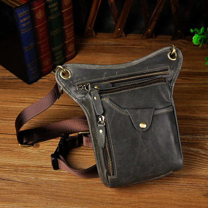 Full grain leather leg bag with zippered pockets and brass snap closures, motorcycle waist pouch dark grey