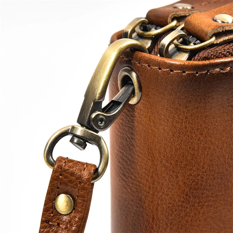 Close-up of brown full grain leather wallet with brass zipper and detachable strap