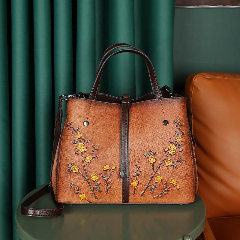 Brown cowhide leather tote bag with yellow floral embroidery, shoulder straps, vintage style