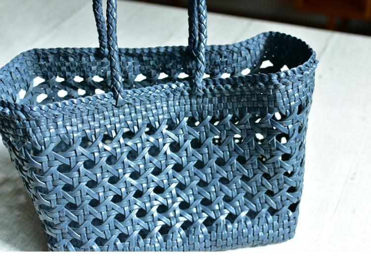 Blue genuine leather handwoven tote bag with open rattan pattern and braided handles