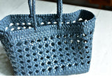 Blue genuine leather handwoven tote bag with open rattan pattern and braided handles