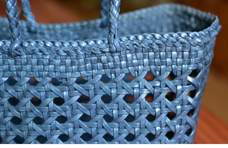 Close-up of blue genuine leather handwoven tote bag with cuboid shape and woven handles
