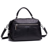 Black genuine leather handbag with top handle, detachable shoulder strap, and front zipper pocket