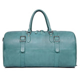 Turquoise full grain leather duffle bag with double handles and buckle strap accents