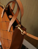 Handcrafted tan cowhide leather handbag with woven pattern and gold hardware