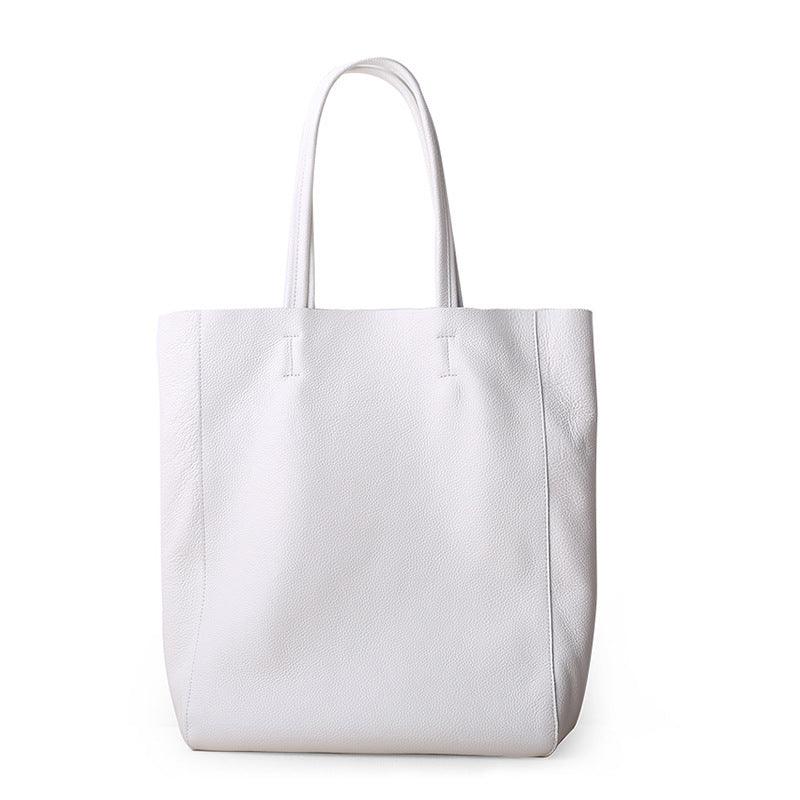 Large white handcrafted leather tote bag with double handles on a plain background