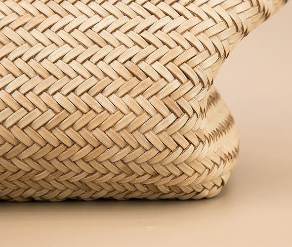 Close-up of handcrafted woven leather tote bag with herringbone pattern