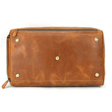 Bottom view of a large handmade full grain leather duffle bag with brass feet and zipper