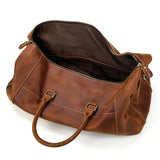 Handmade full grain leather duffle bag in dark brown with spacious interior and handles
