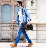 Man walking with dark brown full grain leather duffle bag, travel bag with shoe compartment
