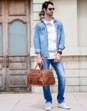 Man holding large dark brown handmade full grain leather duffle bag with shoe compartment