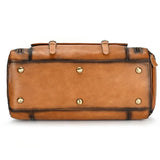 Bottom view of a large handmade full grain leather duffle bag with metal feet and shoe compartment, dark brown.