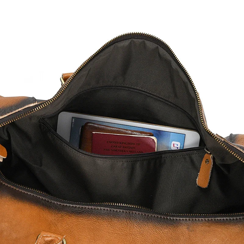 Open full grain leather duffle bag with tablet and passport in inner pocket, travel bag detail